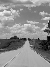 Empty road along countryside landscape