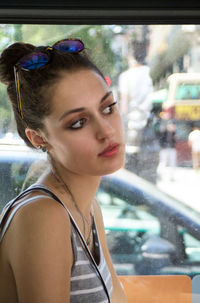 Young woman looking away in bus