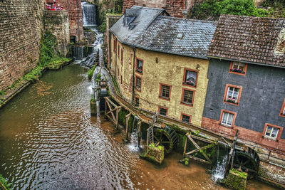 High angle view of canal amidst buildings