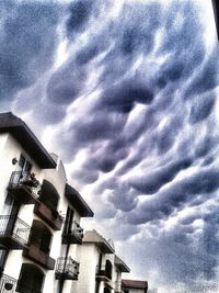 Low angle view of building against cloudy sky