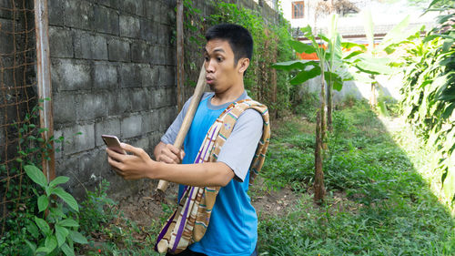 Side view of man using mobile phone