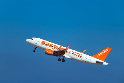 Airplane flying against clear blue sky