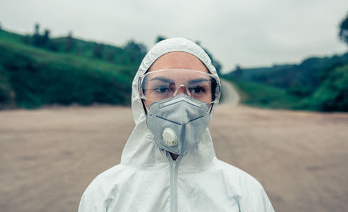 Female scientist wearing protective workwear while standing outdoors