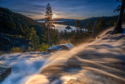 Scenic view of waterfall against sky