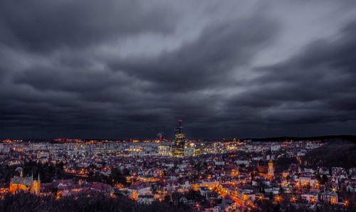 Illuminated cityscape against sky at dusk