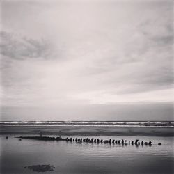 Scenic view of sea against cloudy sky