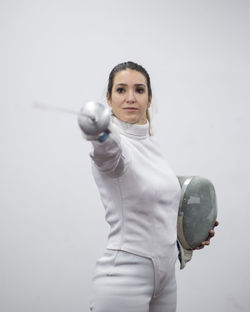 Woman in fencing outfit holding sword