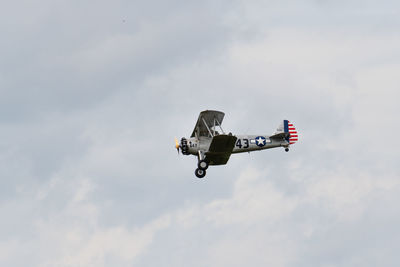 Low angle view of airplane flying against sky