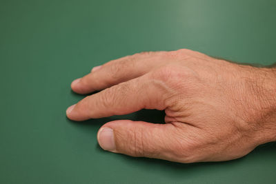 Close-up of person hand on table