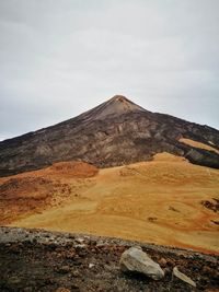 View of volcanic landscape against sky