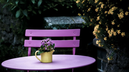 Close-up of flower vase on table in yard