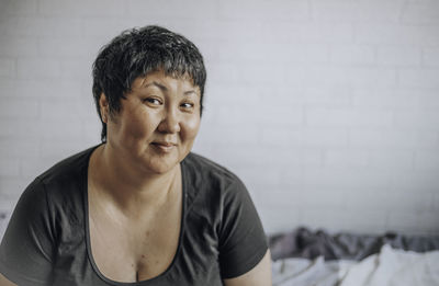 Asian woman of forty with a short haircut on a white background