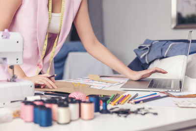 Midsection of woman working on table