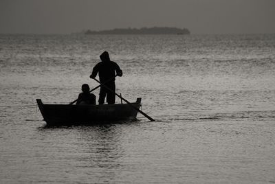 People sitting on boat in sea