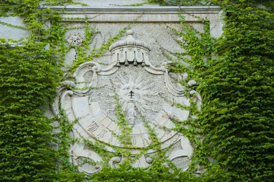 High angle view of sculpture amidst trees and plants