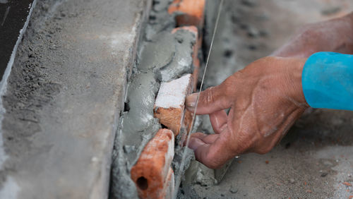 Cropped hands of man working outdoors