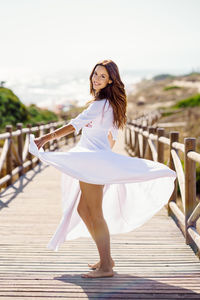 Full length of woman standing against sky