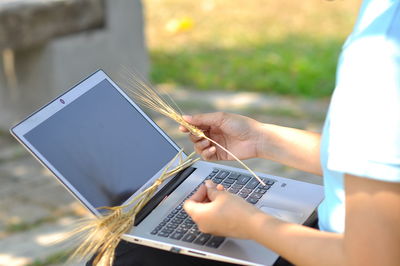 Midsection of woman using mobile phone