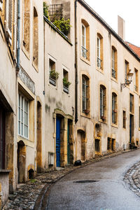 Street amidst buildings in city against sky