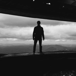 Silhouette man standing on landscape against sky