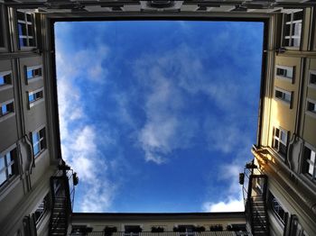 Low angle view of building against cloudy sky