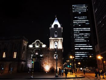 Low angle view of illuminated building against sky at night