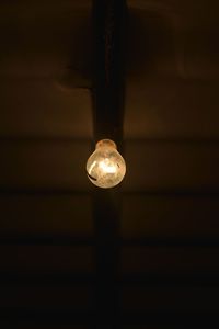 Low angle view of illuminated electric light