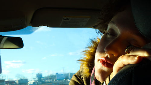 Close-up portrait of woman in car