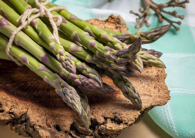 High angle view of asparagus on wooden table