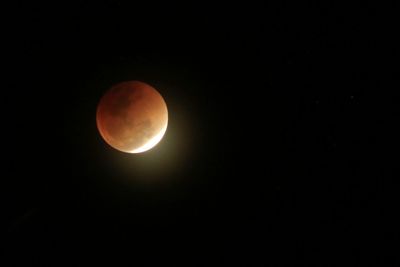Low angle view of moon against clear sky at night