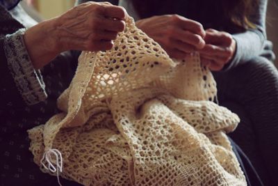 Midsection of women holding woolen scarf