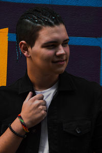 Portrait of young man standing outdoors