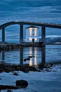 Lepsøyrevet lighthouse with lepsøy bridge in the background, haramsøya, Ålesund, norway.