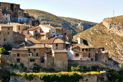 Buildings in town against clear sky