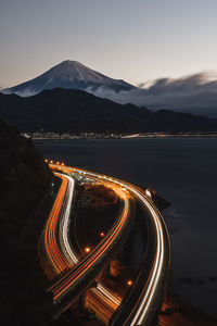 High angle view of light trails on road against sky at night