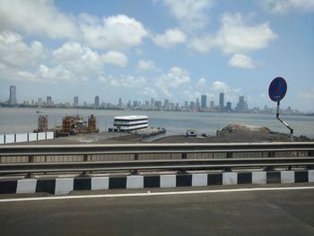 View of cityscape against cloudy sky, mumbai link road