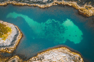 Aerial view of water by rock outdoors