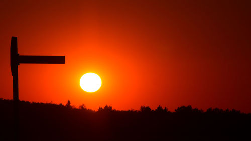 Silhouette landscape against romantic sky at sunset