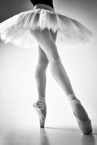 A photo of a ballerina's legs in pointes showing a pa during a performance