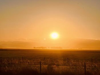 Scenic view of field against sky during sunset