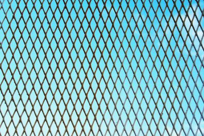 Detail shot of fence against clear blue sky