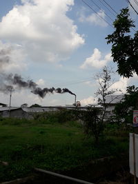 Smoke emitting from chimney against sky