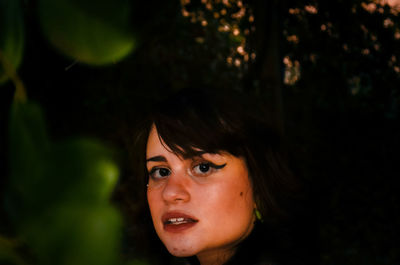 Close-up portrait of young woman in forest