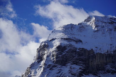 Low angle view of snowcapped mountain against sky