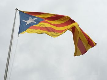 Low angle view of flag against sky