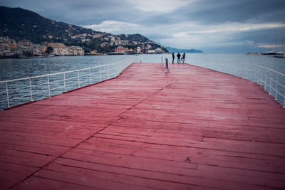 Scenic view of red pontoon against sky