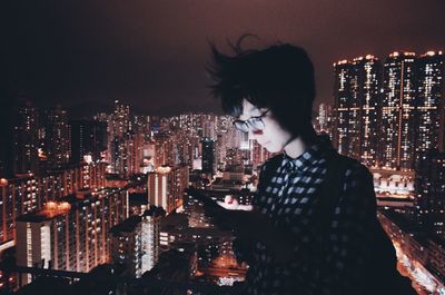 Illuminated cityscape against sky at night