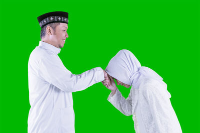 Side view of man against white background