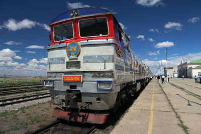 Train at railroad station platform against sky