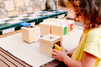 Girl playing with wooden toy at home